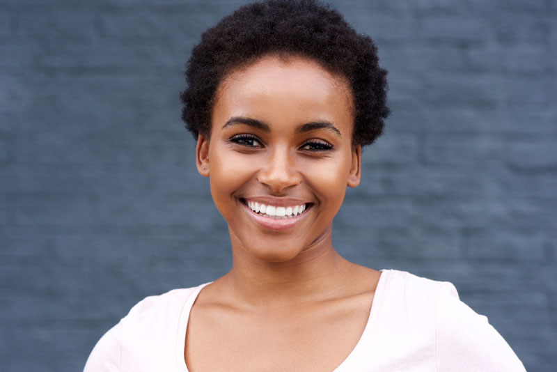 a dental implant patient smiling after the procedure.