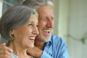 An image of a couple with full mouth dental implants.