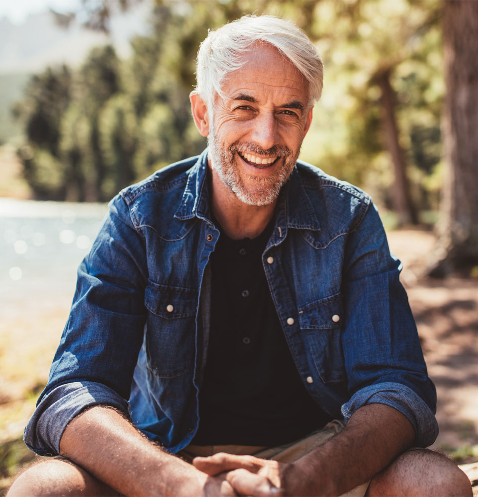 An image of a man smiling with dental implants.